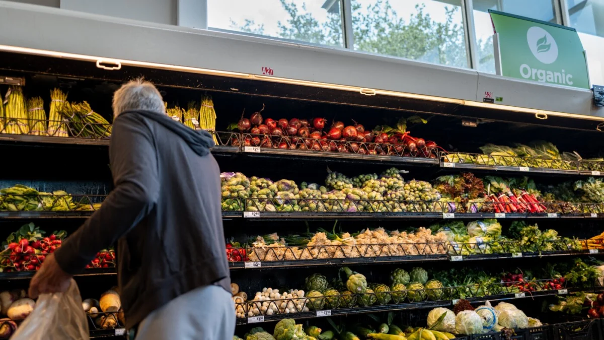 A customer shops for produce in an H-E-B grocery store on May 11 in Austin, Texas. A new report from the Brookings Institution highlights that Americans are struggling financially not just because of inflation, but also