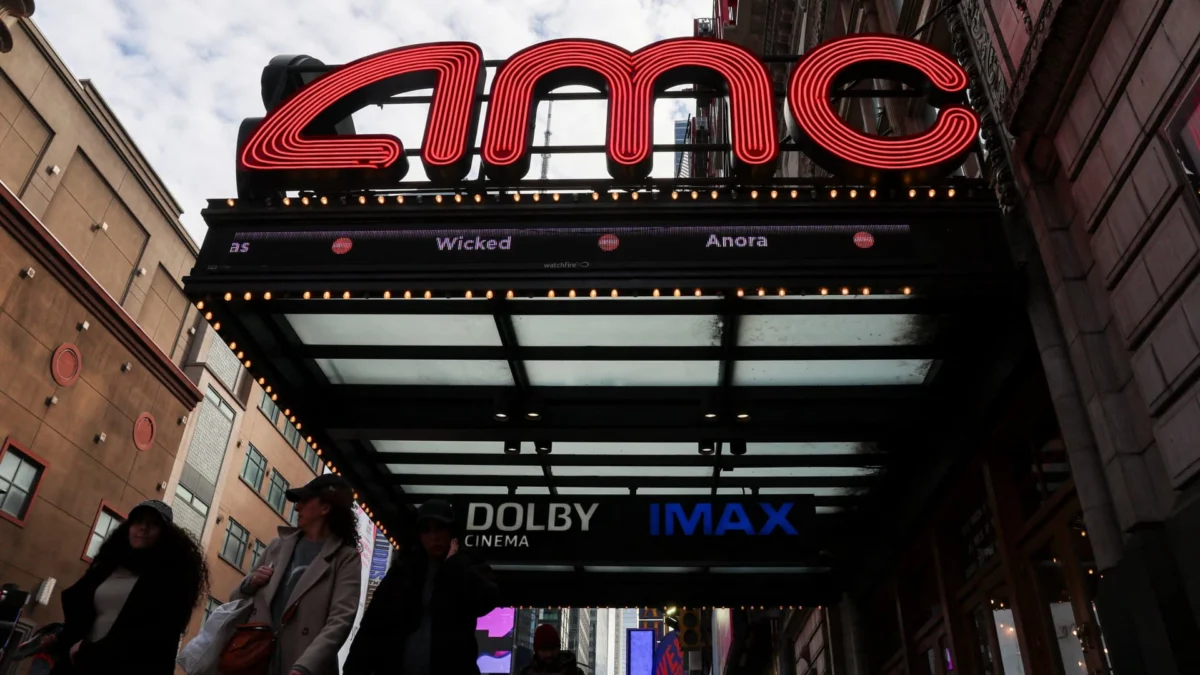 People walk past an AMC theatre in Manhattan in New York City, U.S., February 25, 2025. | Reuters