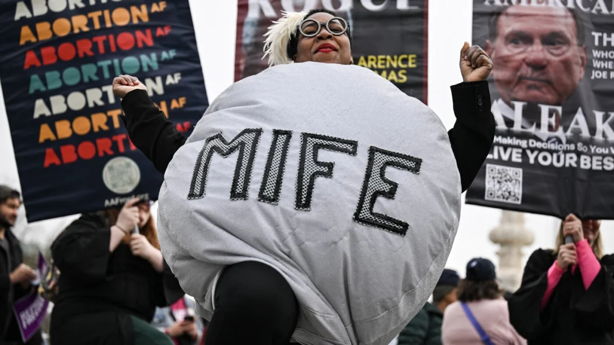 A woman dressed as a mifepristone pill participates in a rally outside the U.S. Supreme Court on April 2, 2025. (Drew Angerer/AFP via Getty Images)
