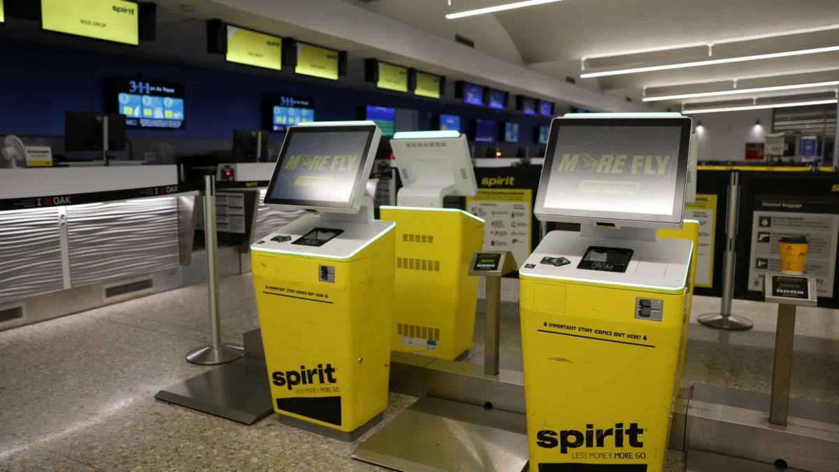 Spirit Airlines check-in kiosks sit idle at Oakland International Airport on August 13, 2025, in Oakland, California. (Justin Sullivan | Getty Images)