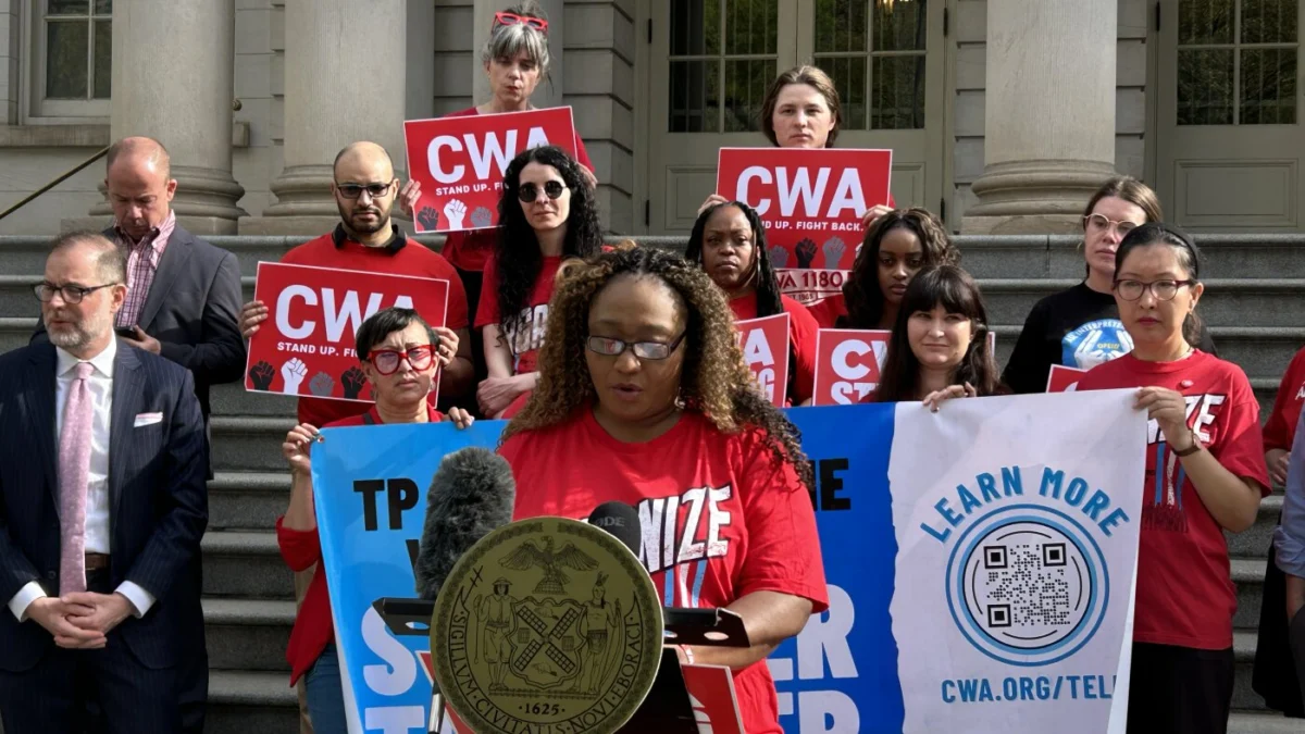 Interpreter Yves Valerus speaks at a LanguageLine press conference in front of New York City Hall in April. LanguageLine interpreters have had their hours drastically cut after the company said it experienced fewer custo
