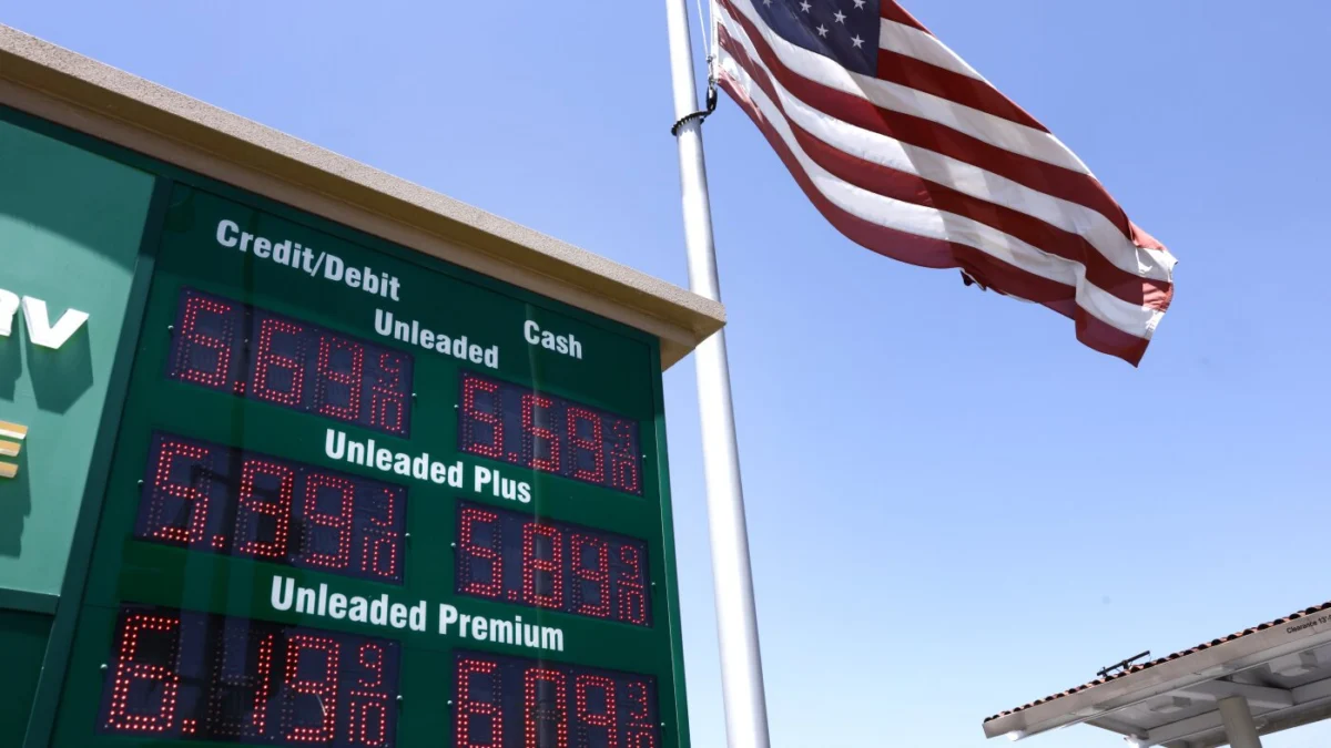 An American flag flies above a sign displaying gas prices at a gas station in Arcadia, Calif., on May 11.