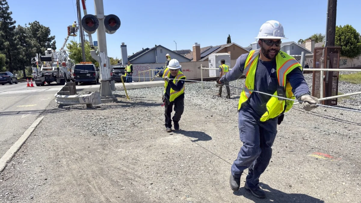 An AT&T crew works to replace stolen copper cables at a railroad crossing in Hayward, California.