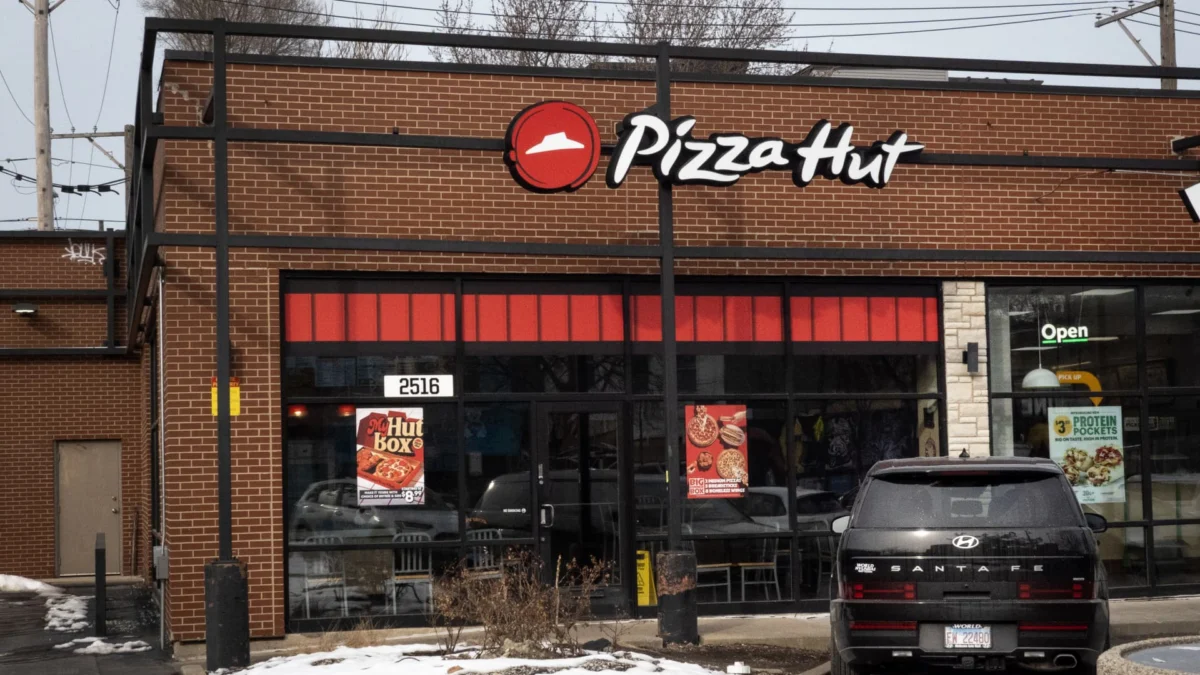 A Pizza Hut sign stands outside a restaurant as markets react to Yum Brands’ sale of Pizza Hut.