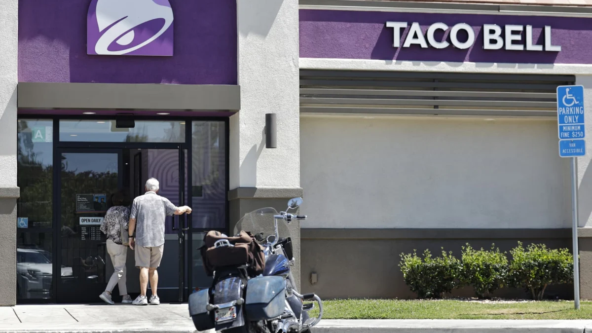 Customers enter a Taco Bell restaurant on July 14, 2026, as markets digest the cyclosporiasis scare.
