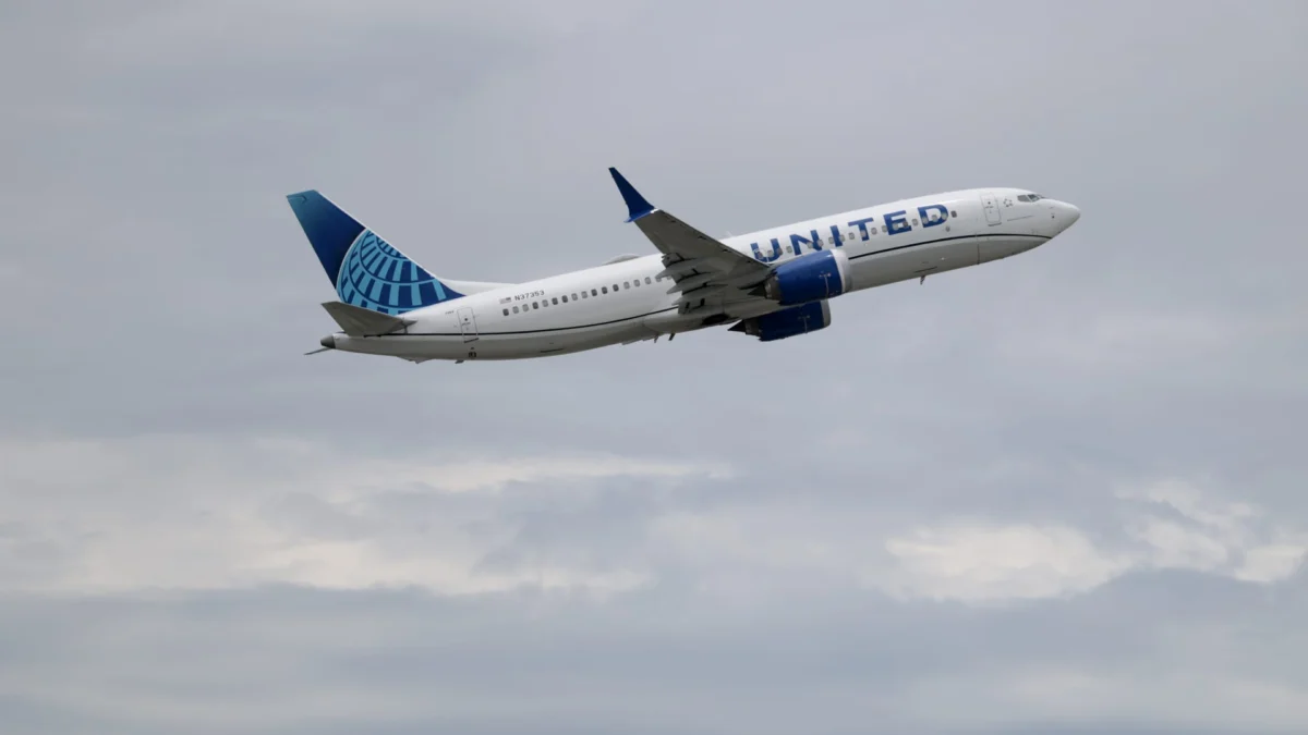 A United Airlines plane taxis on the runway during a busy travel season.
